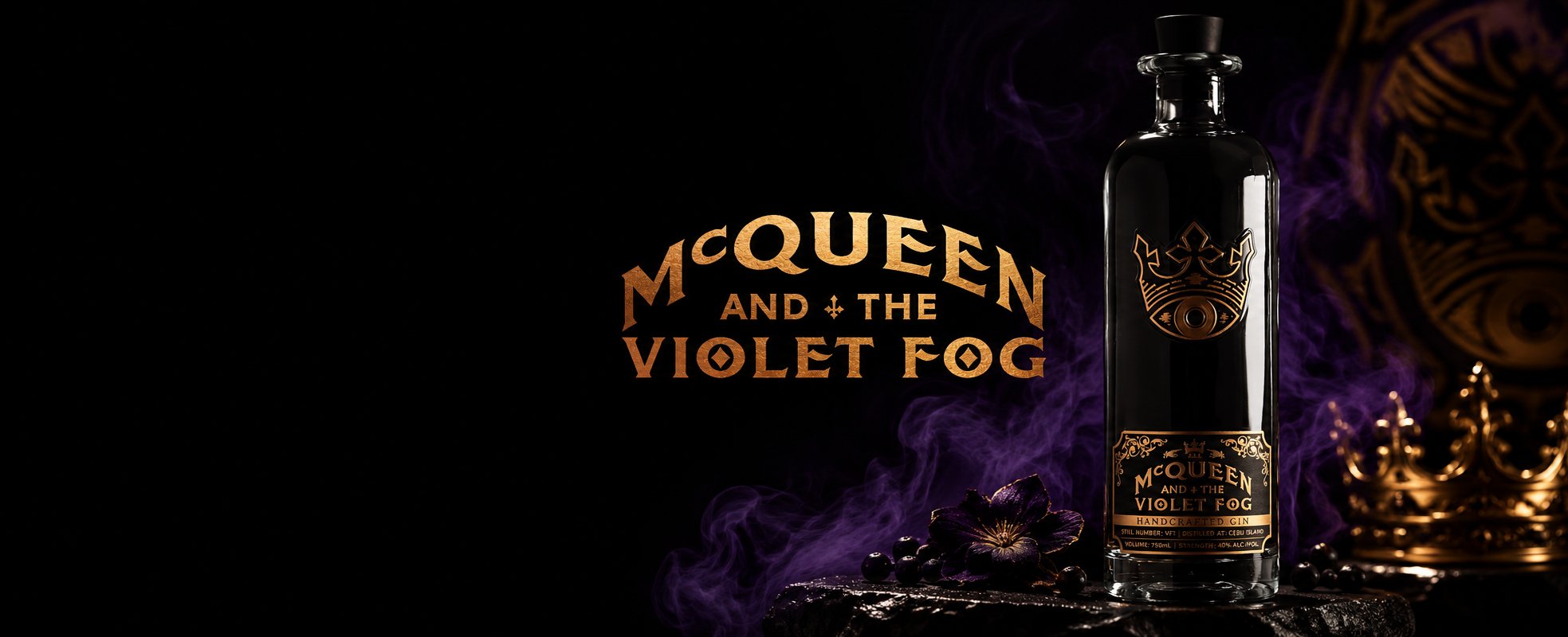 A bottle of McQueen and the Violet Fog handcrafted gin with a gold crown-and-eye emblem, set against a black background swirling with violet smoke, alongside the gothic gold McQueen and the Violet Fog logo, a gold crown, dark flowers and blackberries.
